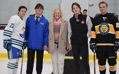 Participating in the ceremonial puck drop with Dayna Gladstein, Executive Vice President of Newport Mental Health, are Salve Regina captain #22 Johnny Mulera, Wentworth captain #28 Josh Faussett, and Salve students representing the men’s lacrosse and baseball teams. (Emily Winslow photo)